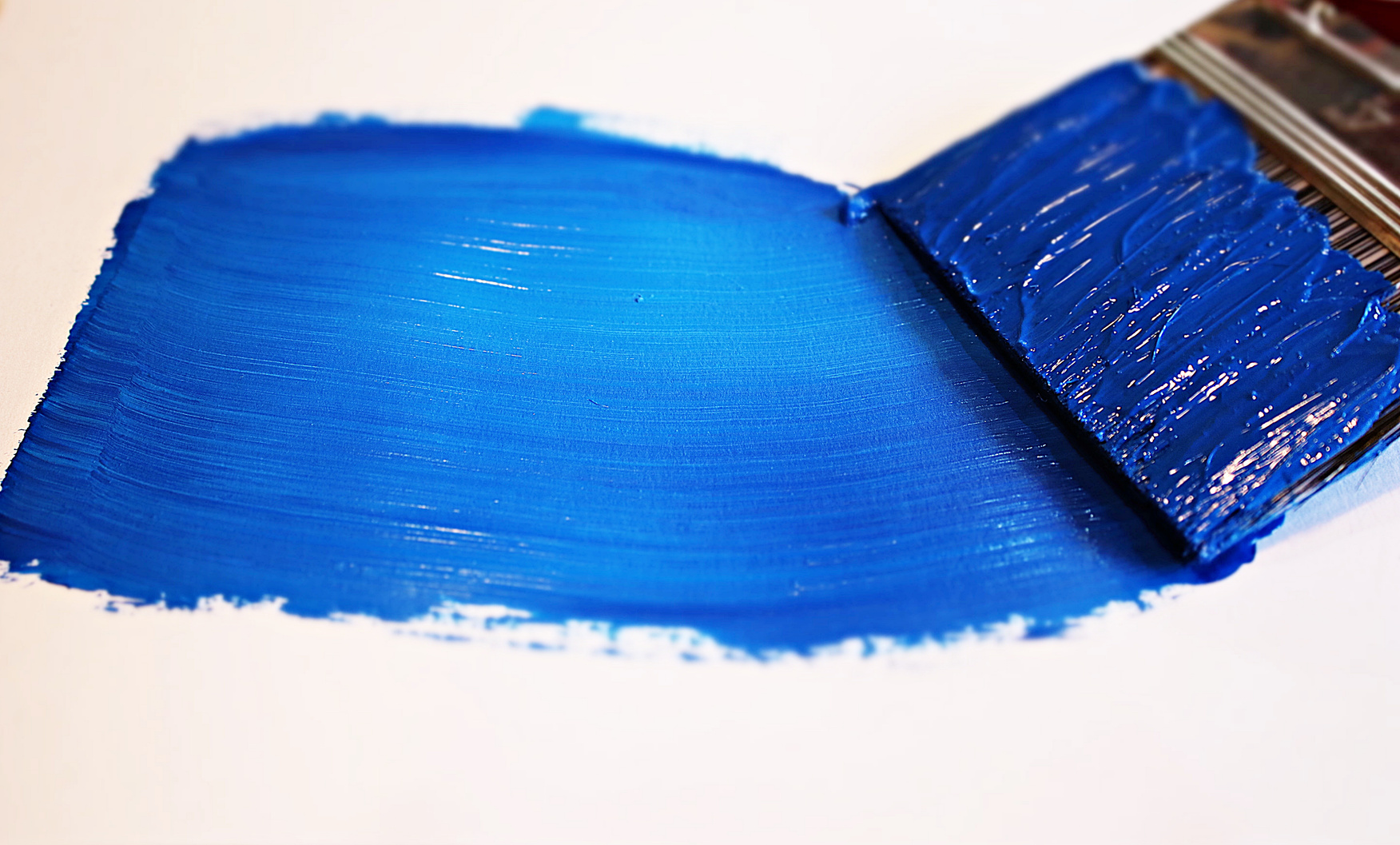 Rich blue paint and brush
